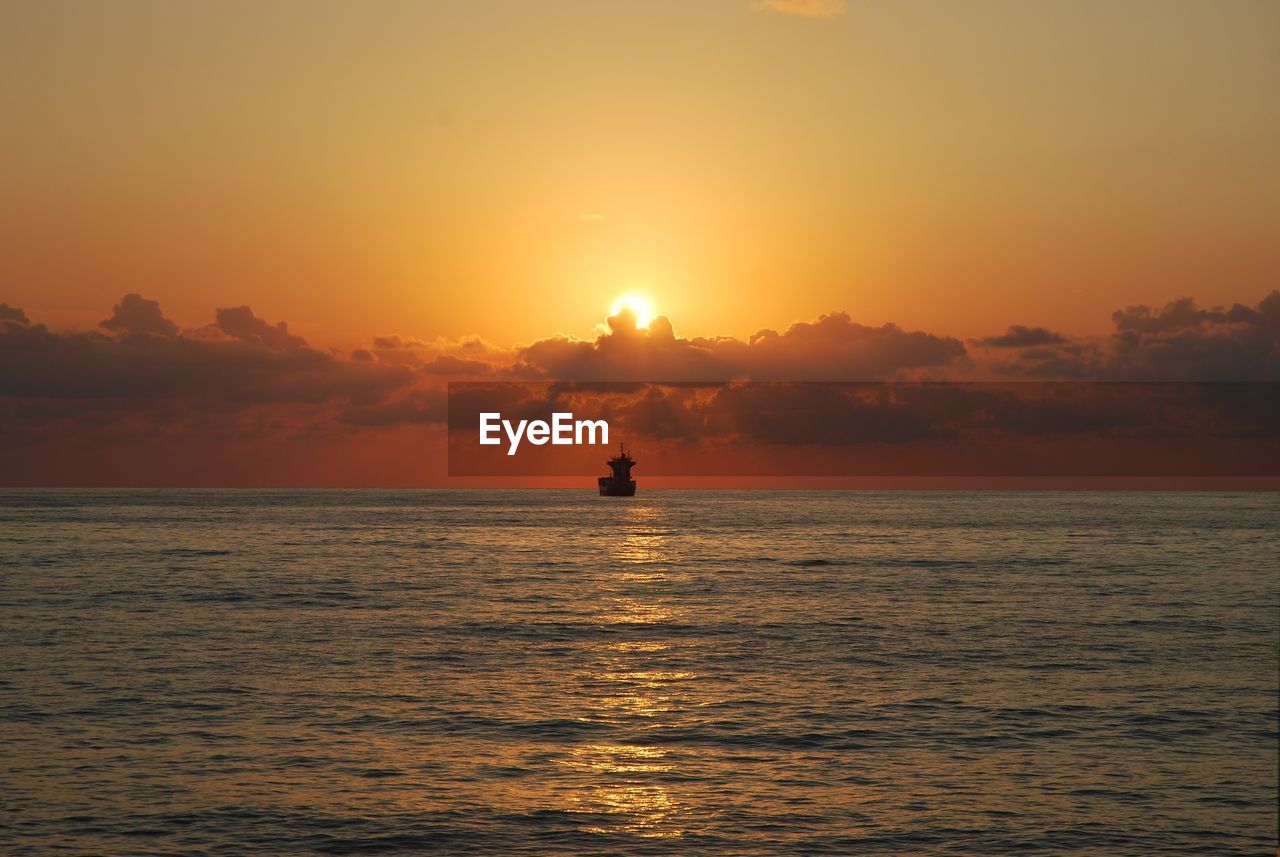 Scenic view of calm sea at sunset