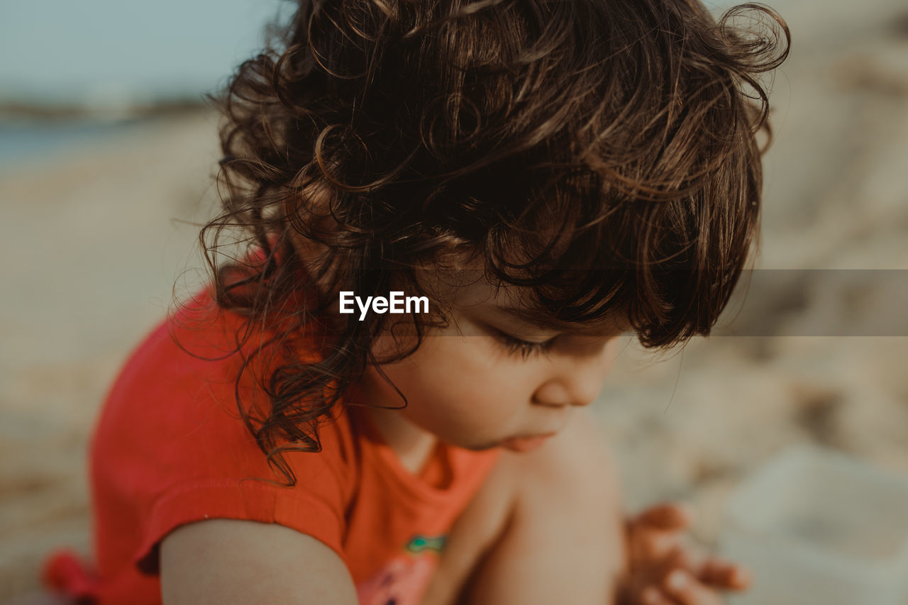 Close-up of cute girl playing on beach