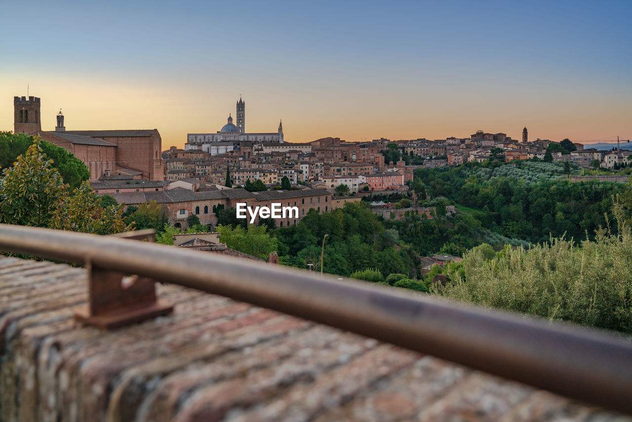Cityscape against clear sky during sunset