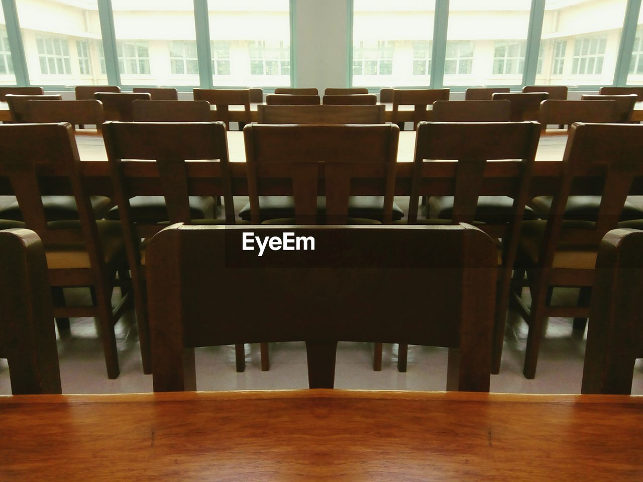 EMPTY CHAIRS AND TABLES IN ROOM