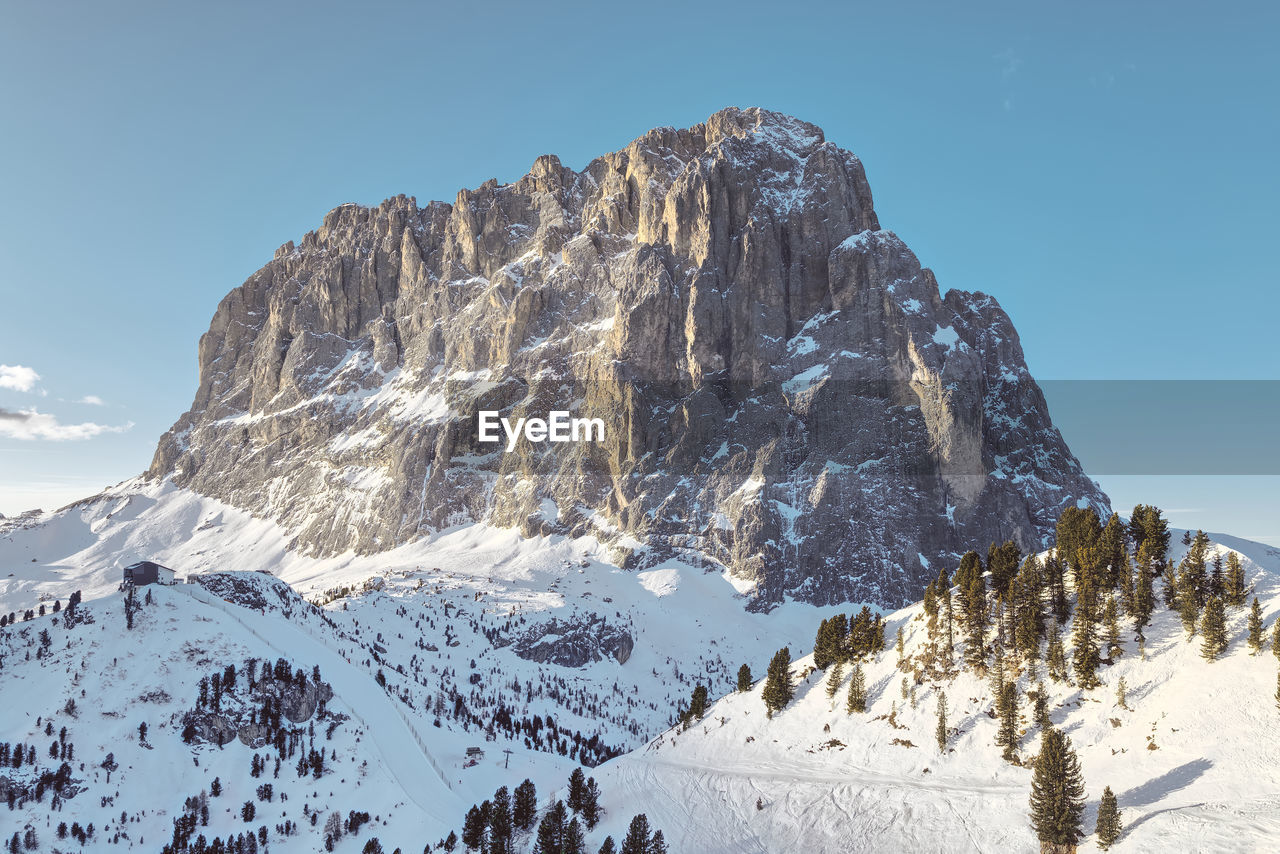 Gorgeous winter morning view of  canazei, dolomites, italy where skiers are about to start a new day