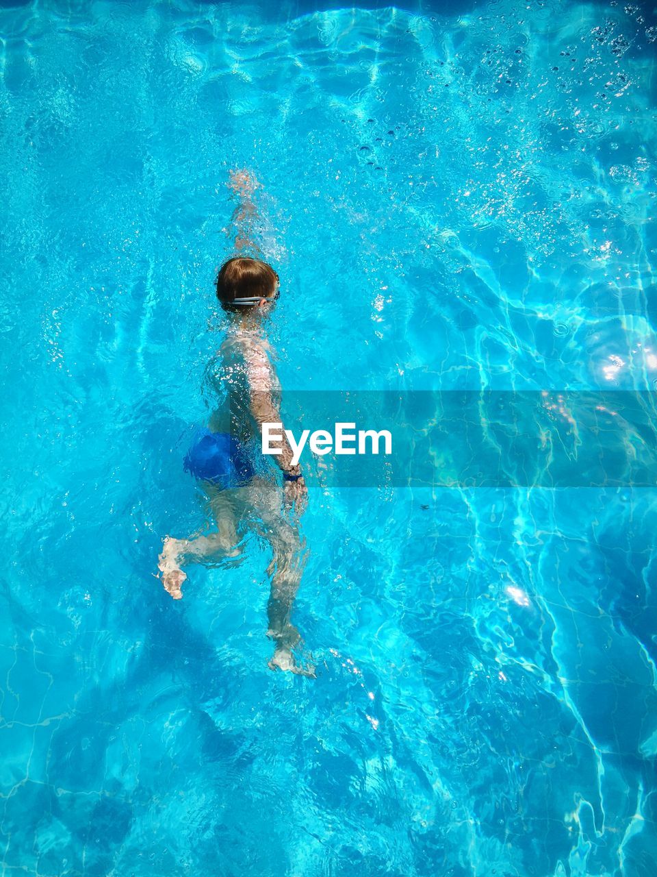 High angle view of boy swimming in pool