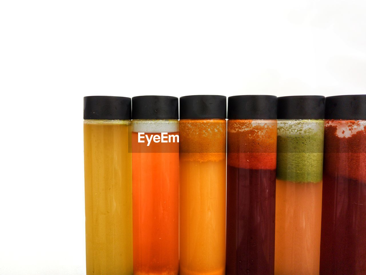 orange, in a row, white background, multi colored, indoors, studio shot, education, no people, variation, group of objects, cut out, food and drink, container, orange color