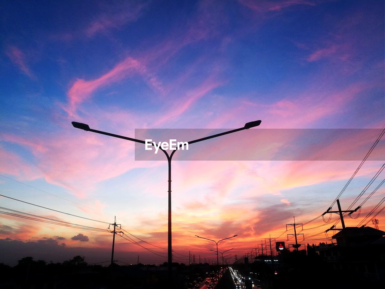 Low angle view of silhouette street against sky during sunset