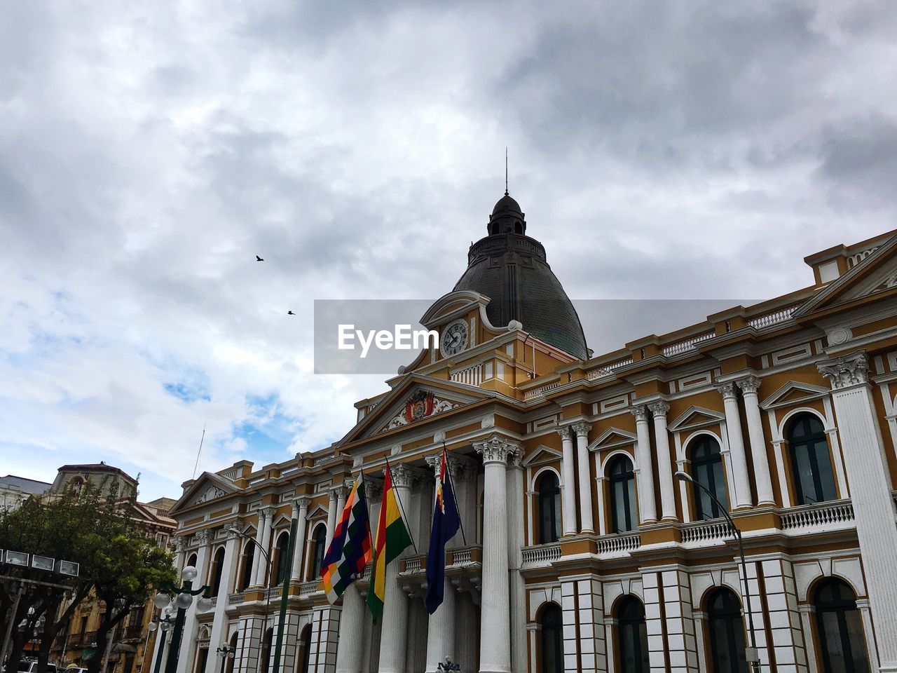 Low angle view of parliament building against cloudy sky