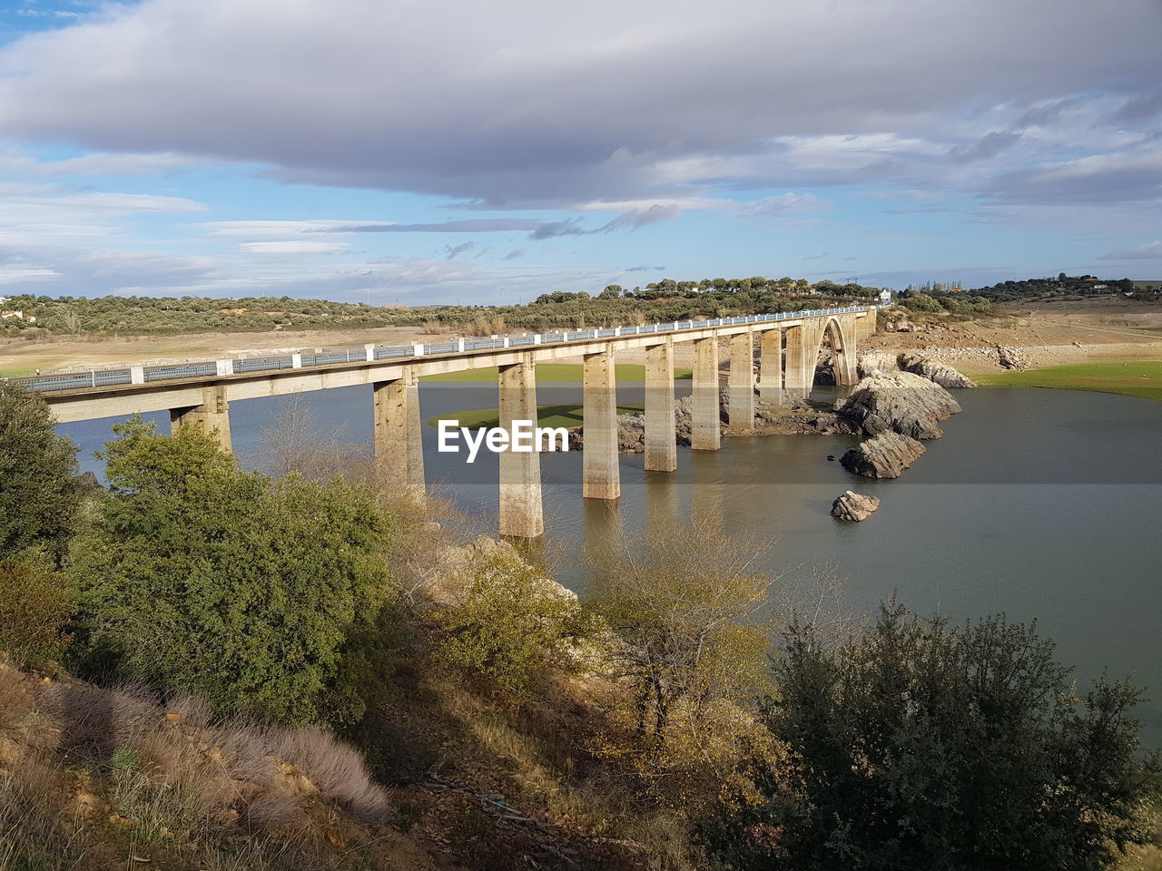 BRIDGE ON RIVER AGAINST SKY