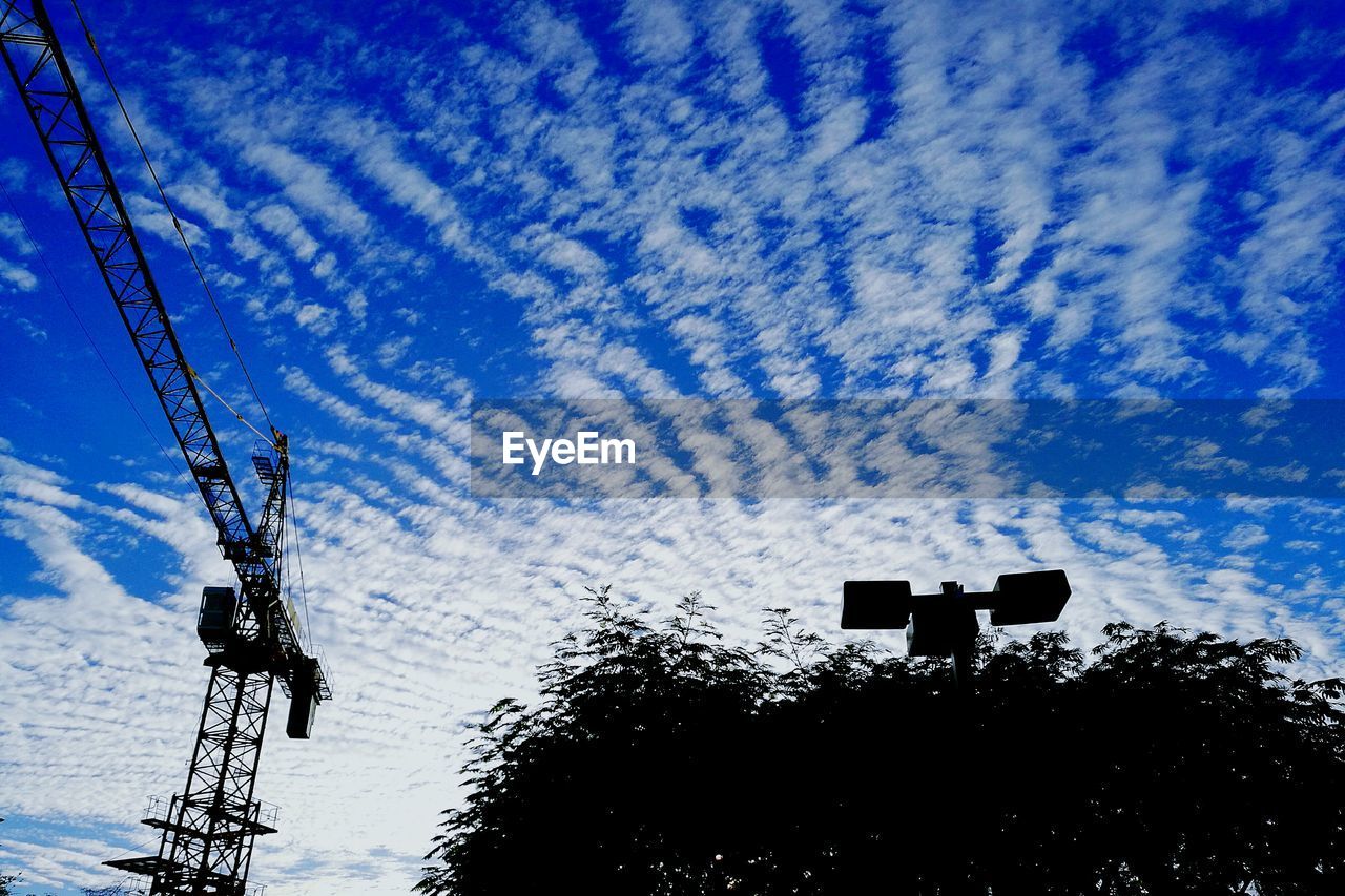 SILHOUETTE OF TELEPHONE POLE AGAINST DRAMATIC SKY