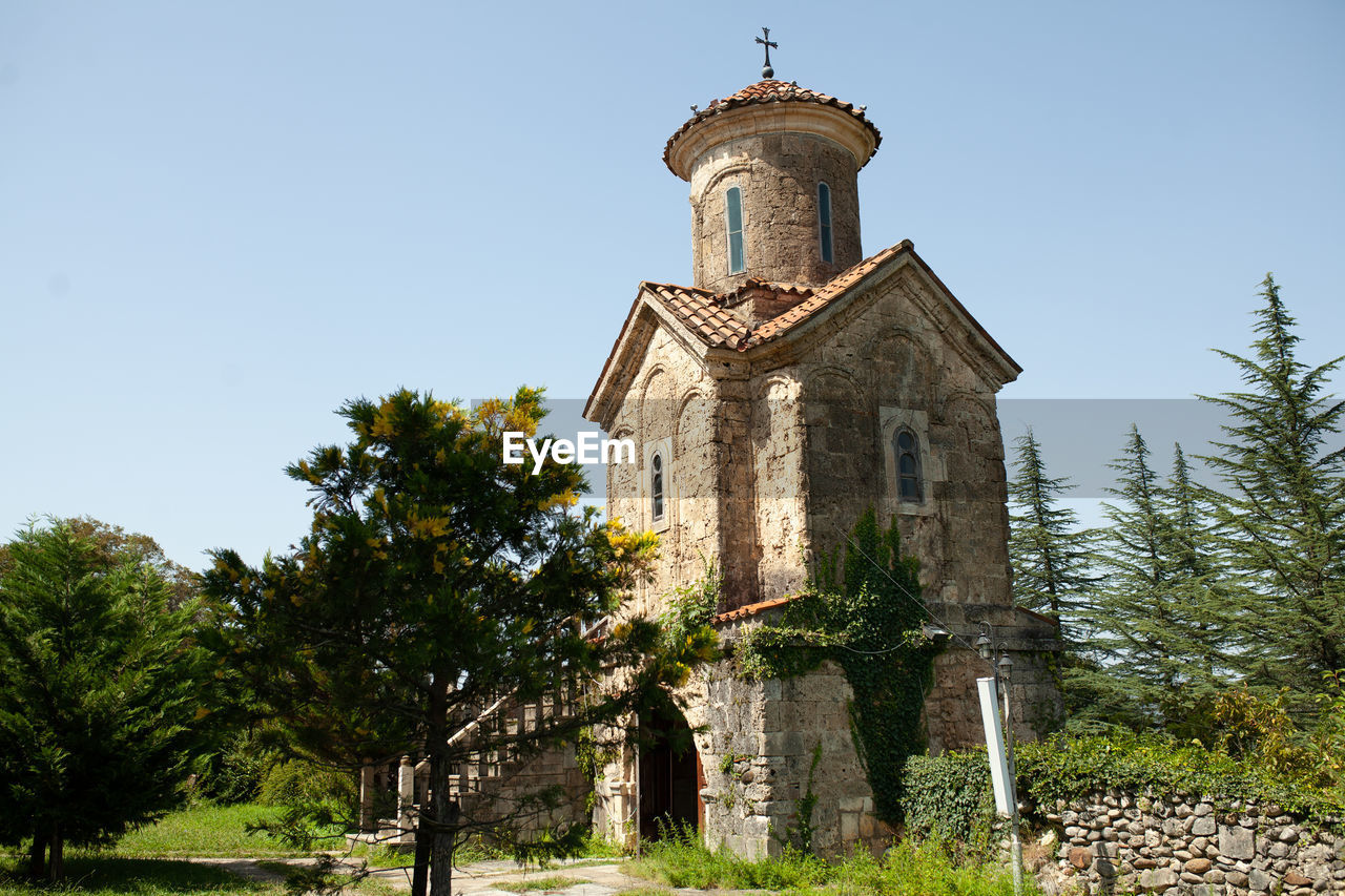 Low angle view of trees and martvili monastery against sky