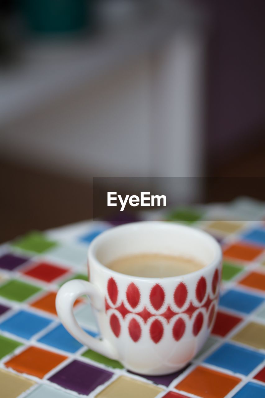 CLOSE-UP OF CUP OF COFFEE ON TABLE