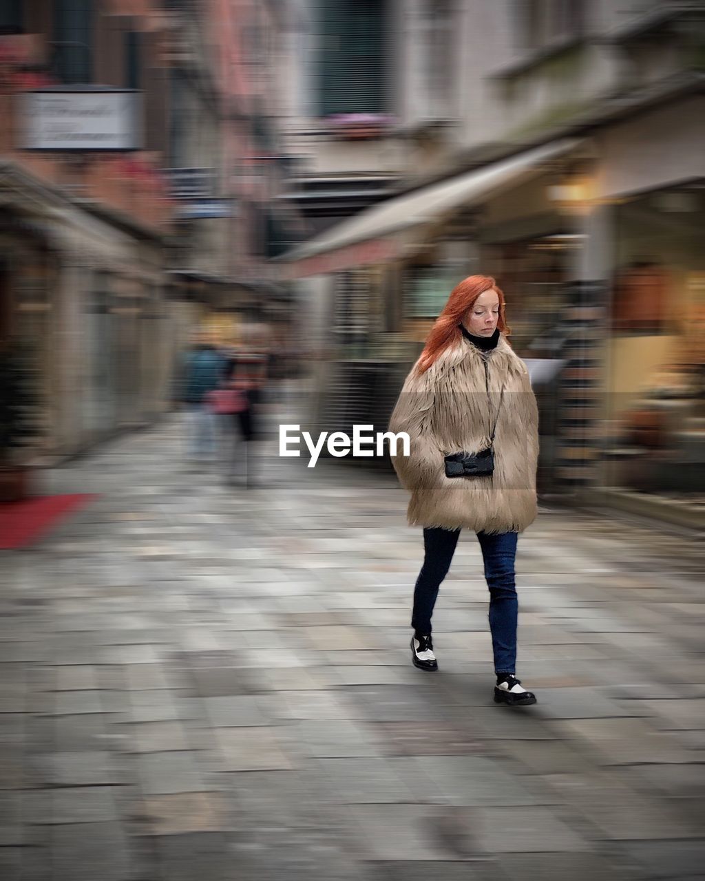 YOUNG WOMAN WALKING ON STREET