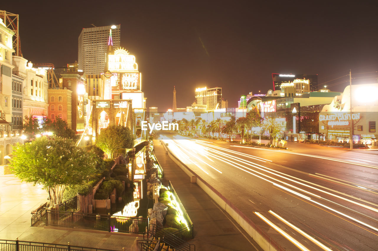 LIGHT TRAILS IN CITY AGAINST SKY