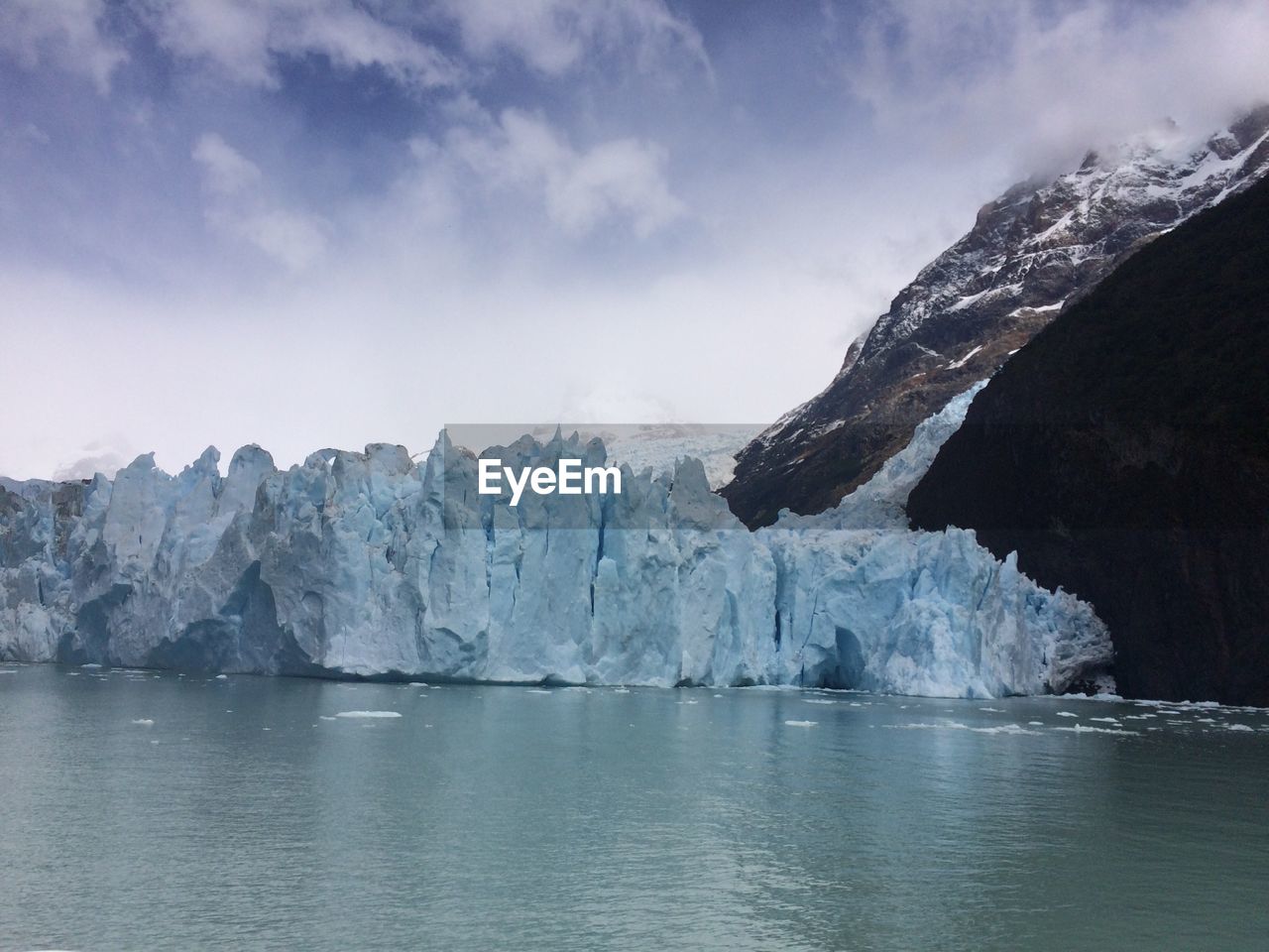 Scenic view of sea and mountains against sky