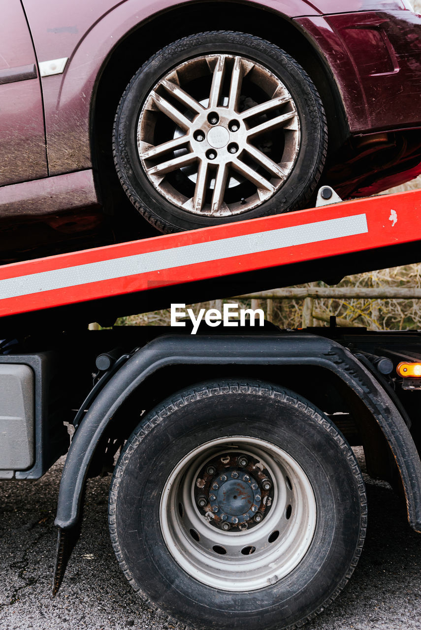 Side view of tow truck with car after breakdown on the highway