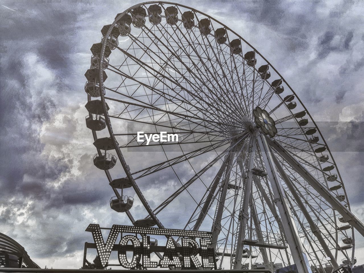 LOW ANGLE VIEW OF FERRIS WHEEL AGAINST SKY