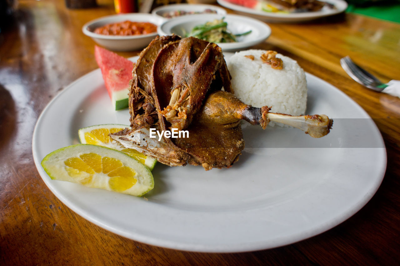 Bebek bengil served in plate on table