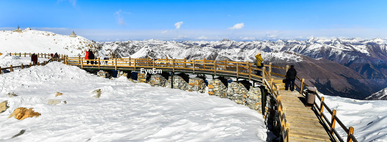 Scenic view of snow covered mountains against sky