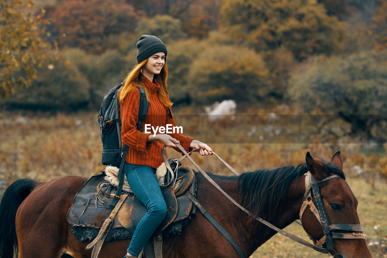 WOMAN RIDING HORSE