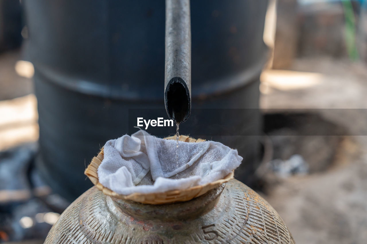 Distillation of laos whisky in a village near luang prabang, laos, south-east asia