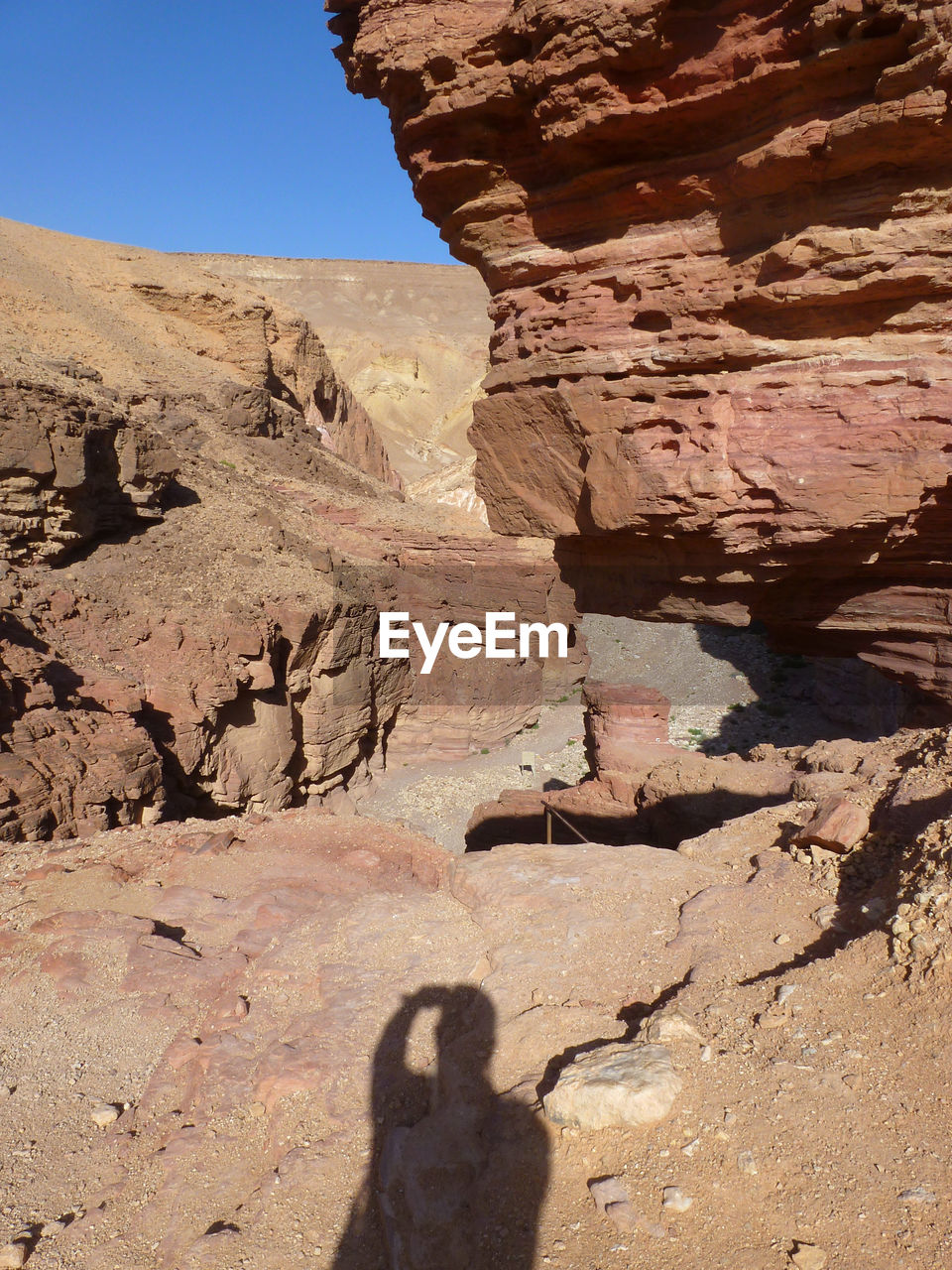 SHADOW OF MAN ON ROCK FORMATIONS