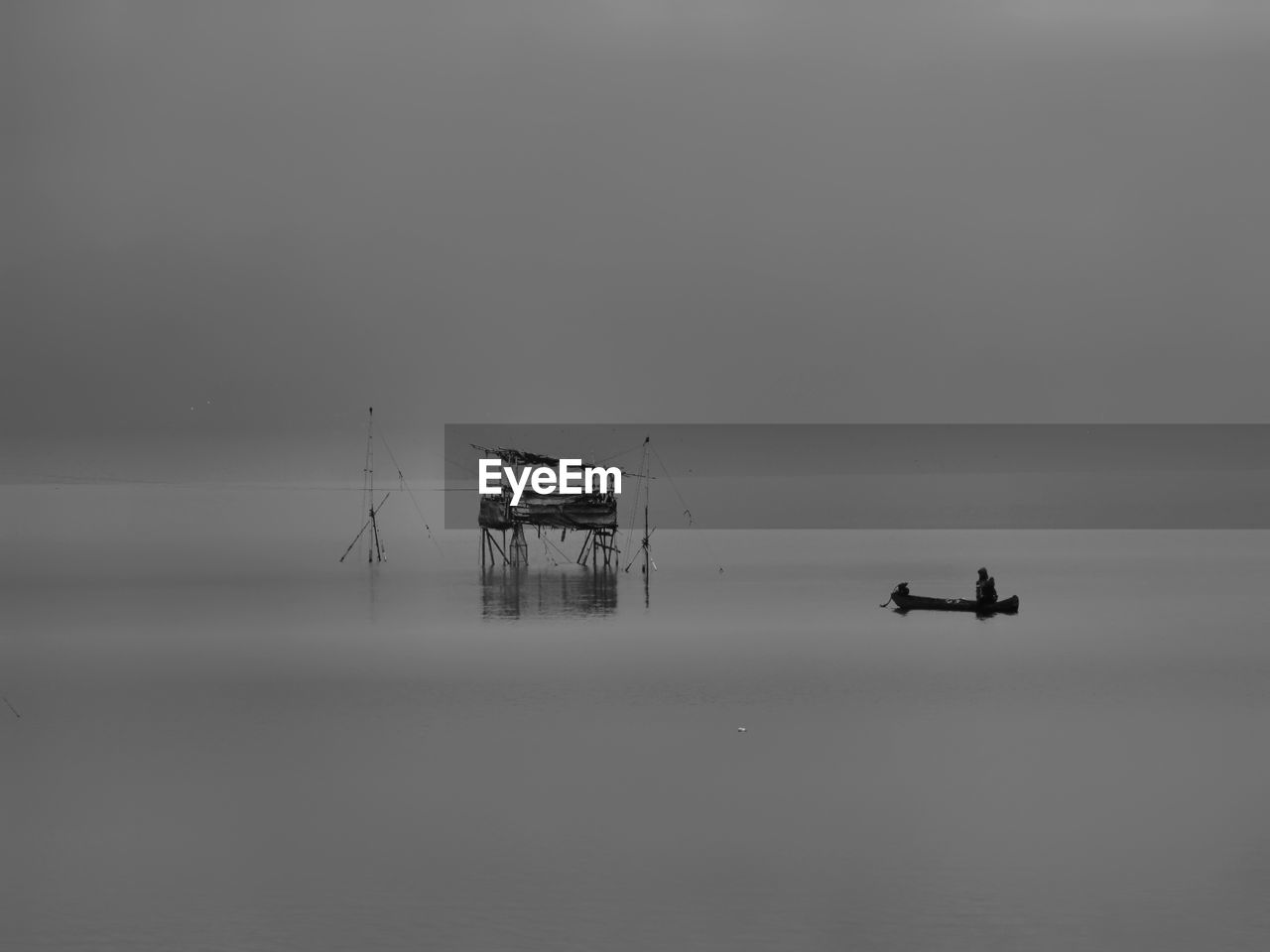 SILHOUETTE OF SHIP IN SEA AGAINST SKY