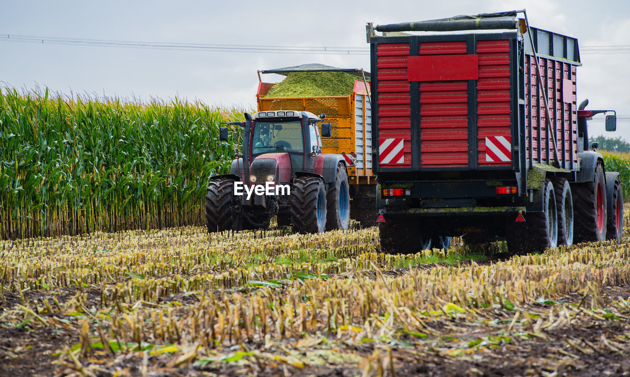 Agricultural machinery on field against sky