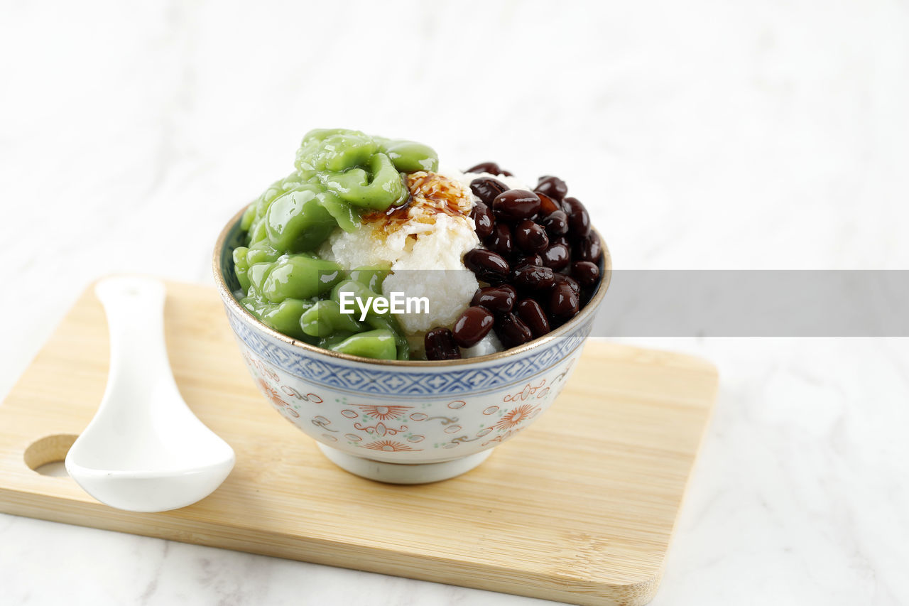 Malaysian desserts called cendol. made from crushed ice cubes, red bean, variety of sweets, fruits. 