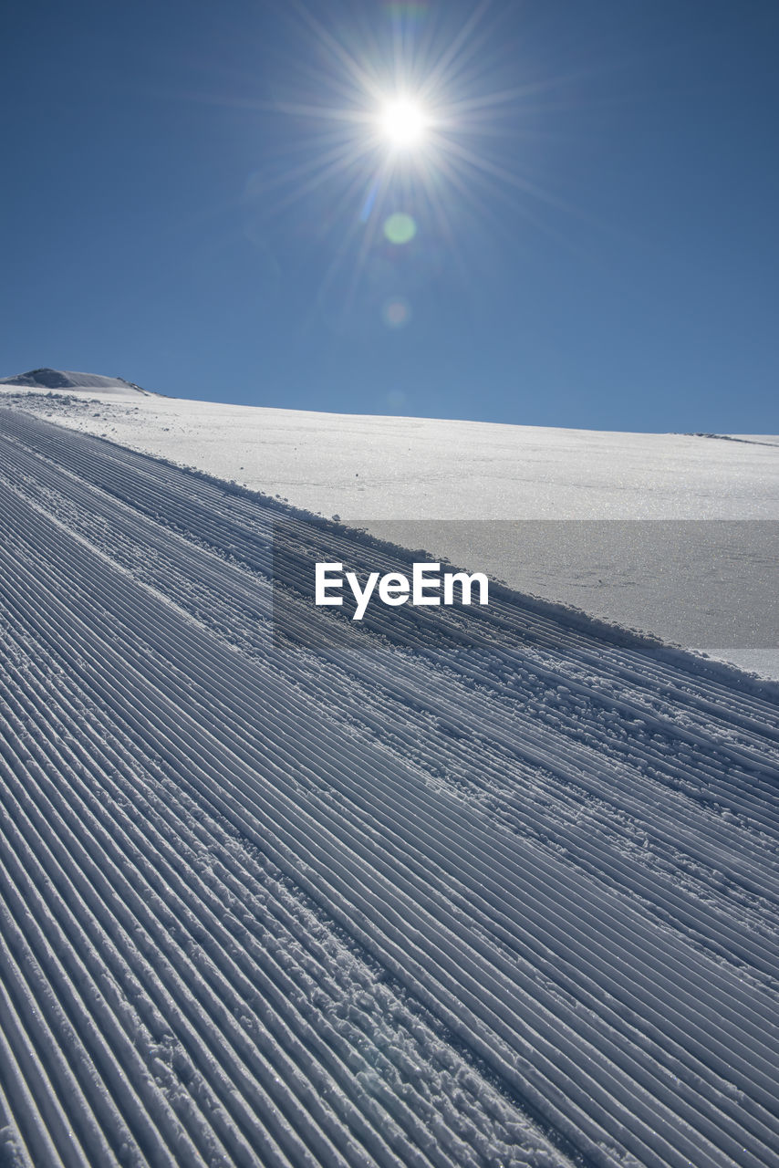 Scenic view of snowcapped landscape against clear blue sky