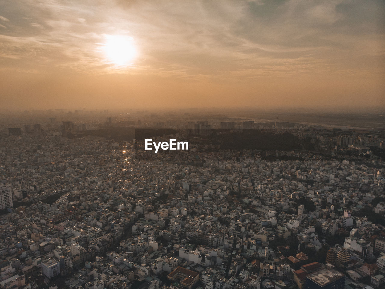 HIGH ANGLE SHOT OF TOWNSCAPE AGAINST SKY AT SUNSET