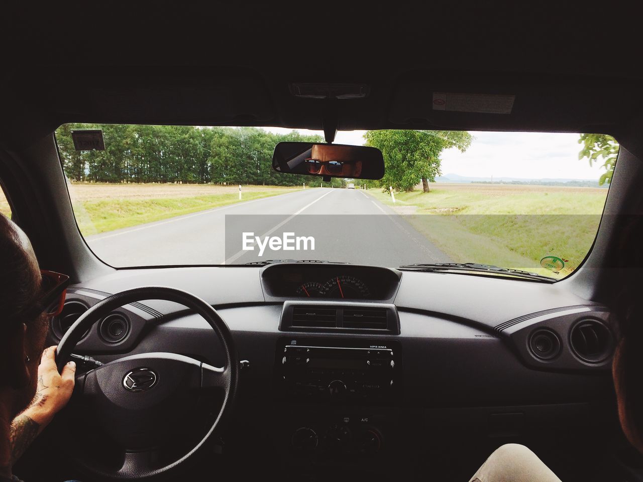 CLOSE-UP OF MAN IN CAR