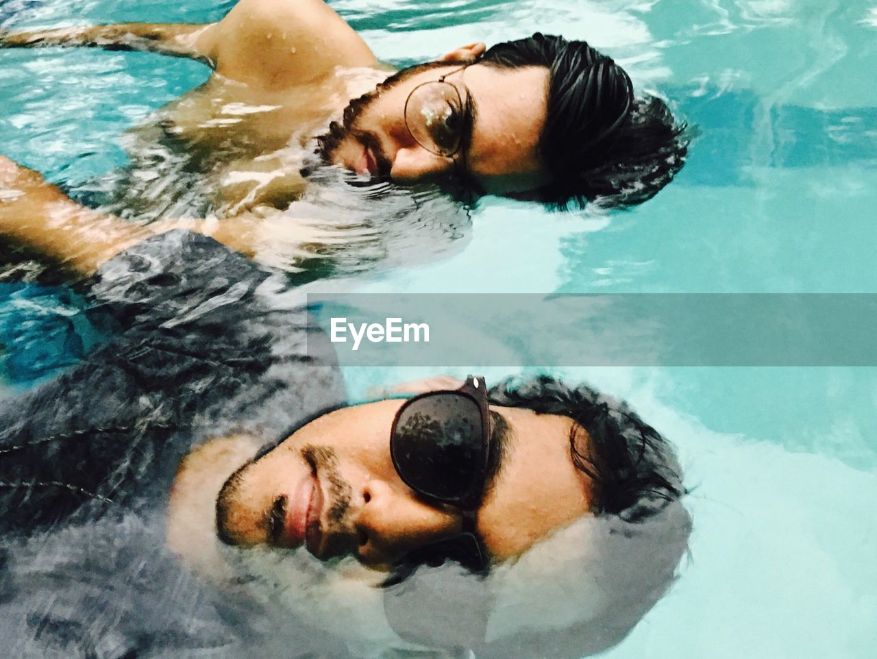 Portrait of friends in swimming pool