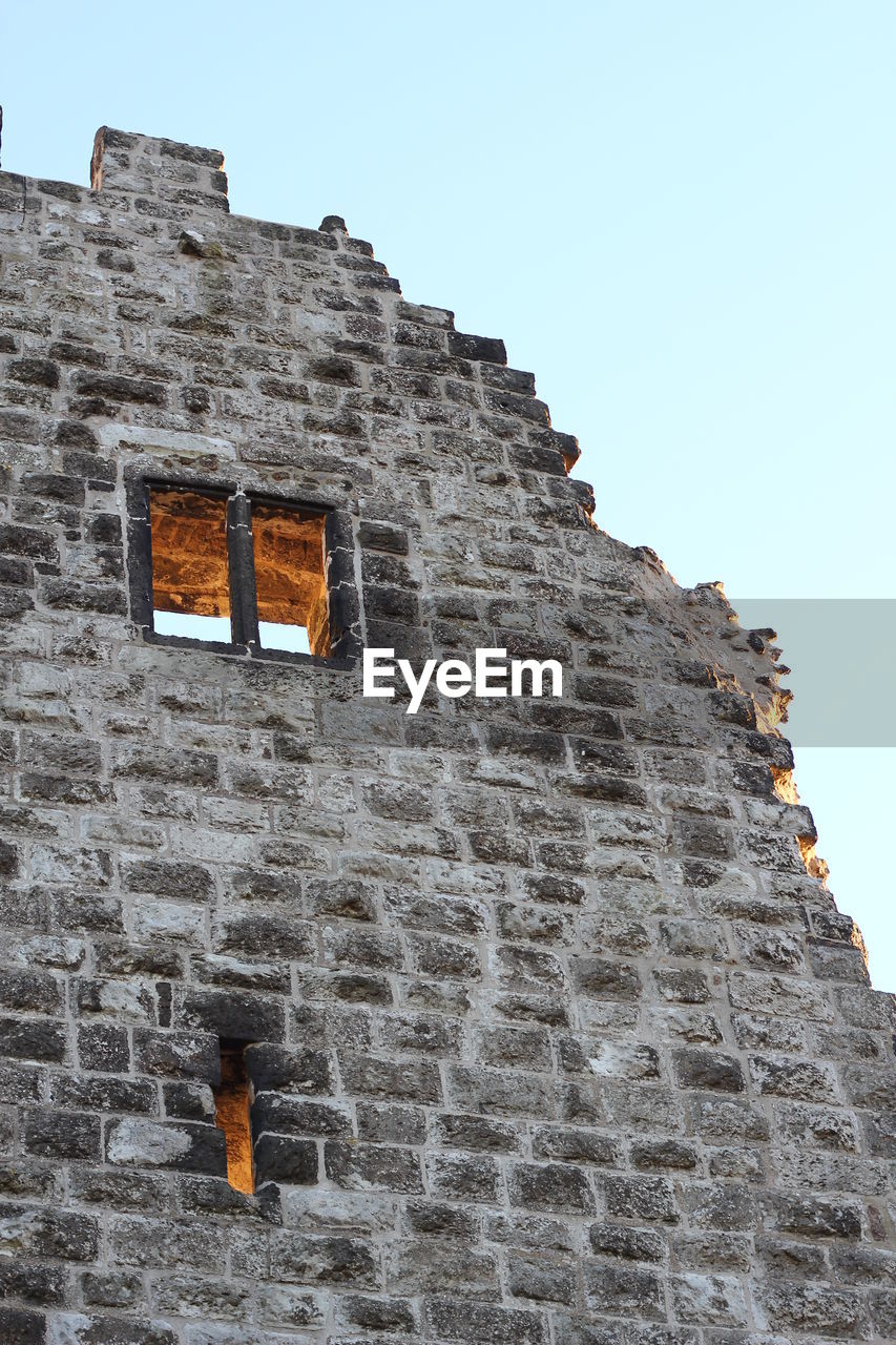 LOW ANGLE VIEW OF CASTLE AGAINST CLEAR SKY