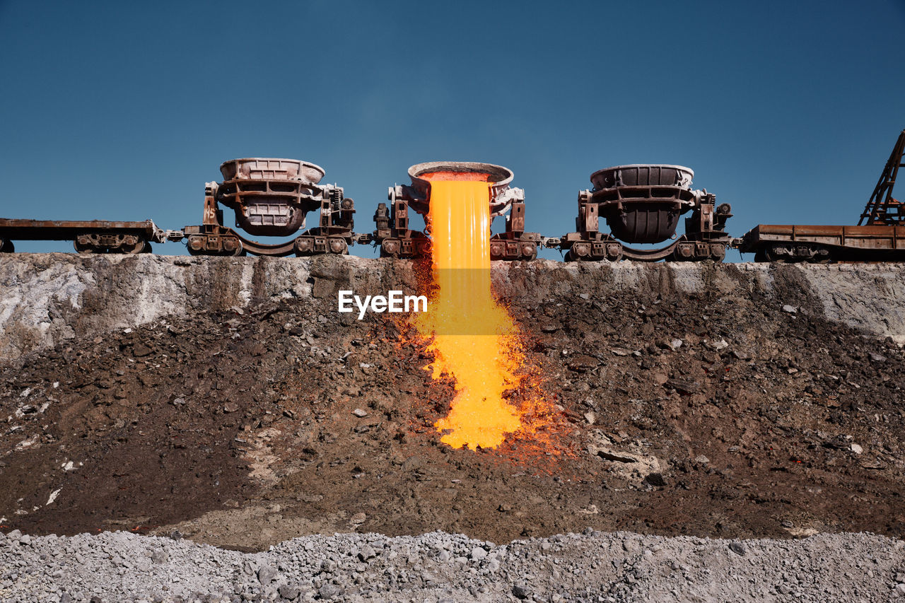 industry, sky, soil, nature, construction industry, no people, blue, heat, road construction, transportation, outdoors, clear sky, asphalt, day, architecture