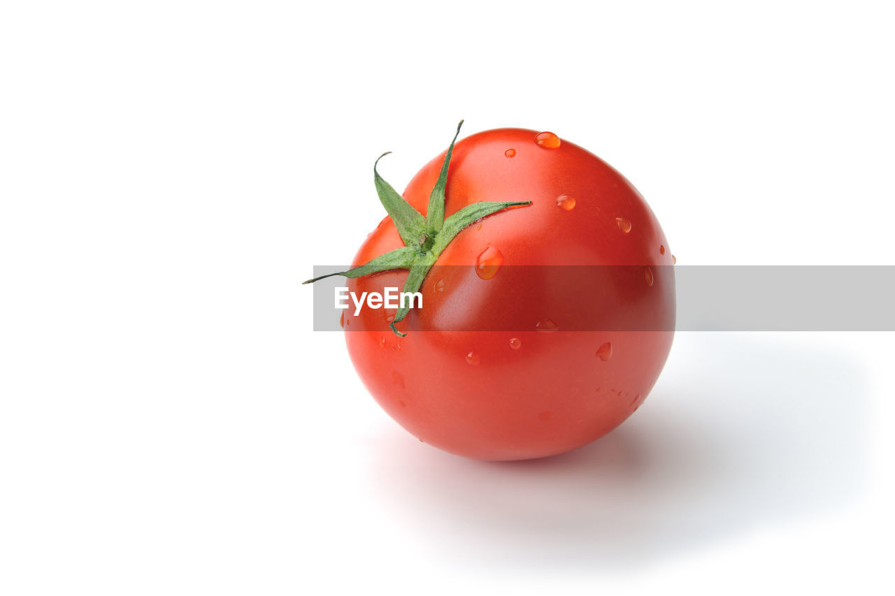 CLOSE-UP OF STRAWBERRY AGAINST WHITE BACKGROUND