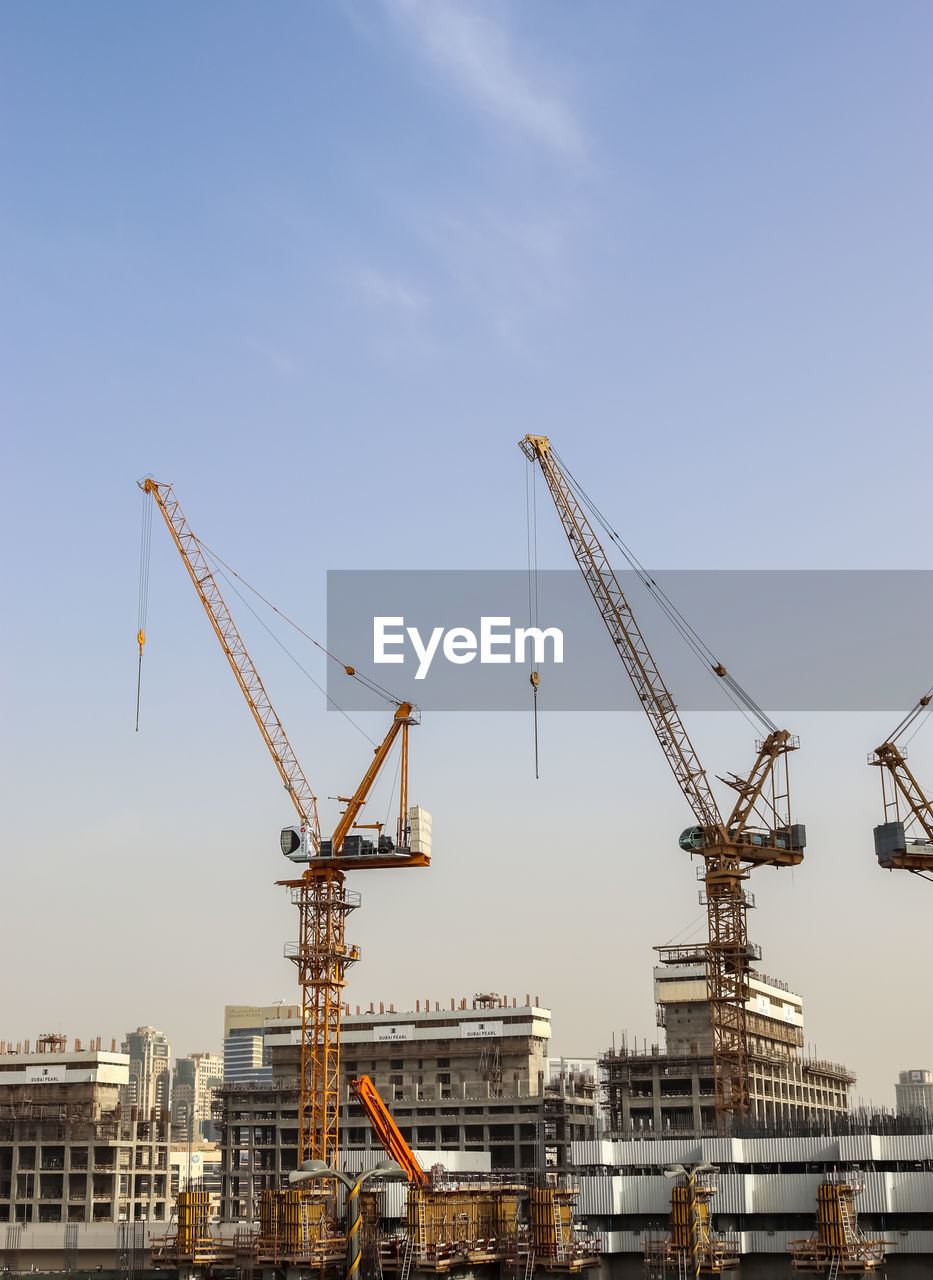 Big cranes at construction sites in the city of dubai in the united arab emirates