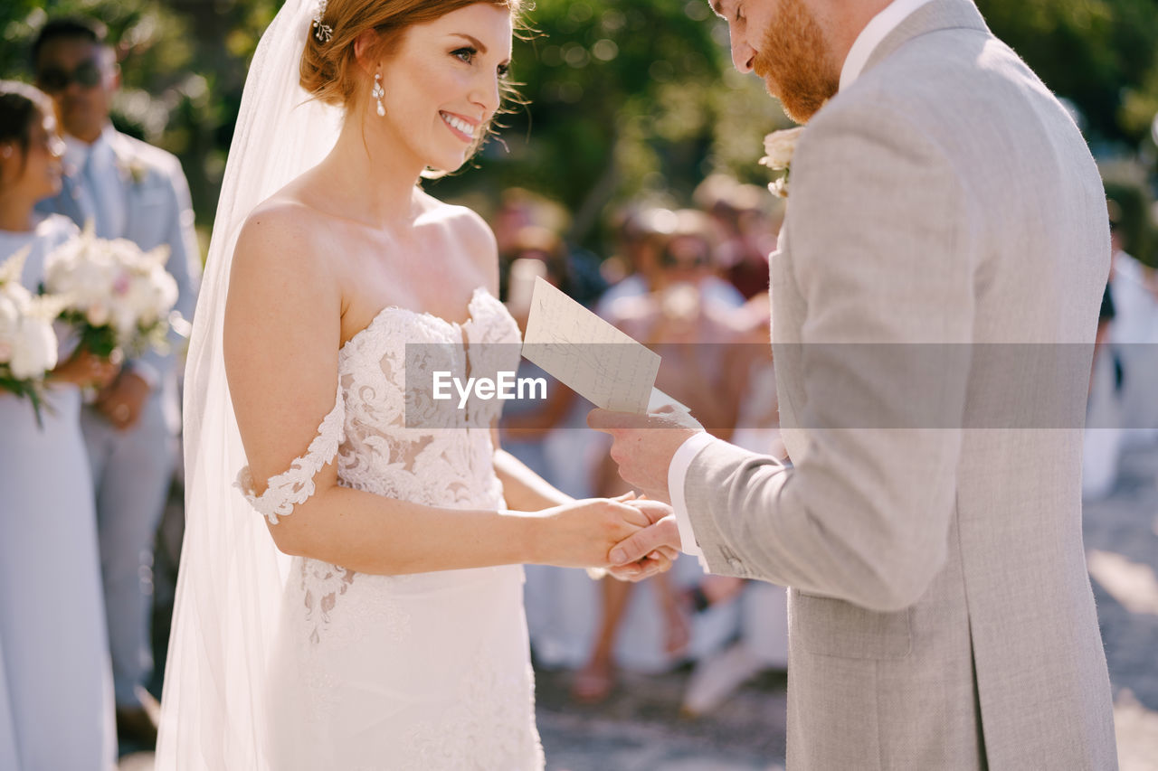 portrait of couple holding hands in city