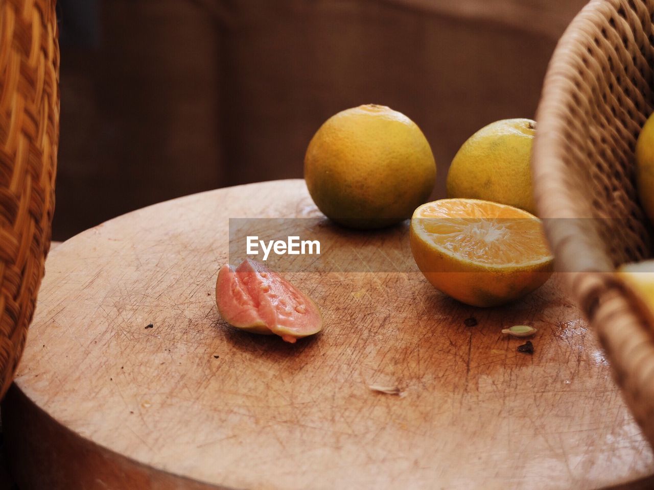 Guava slice by oranges on table