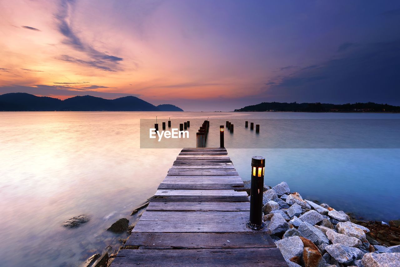 Sunset over the wooden jetty in marina island, pangkor