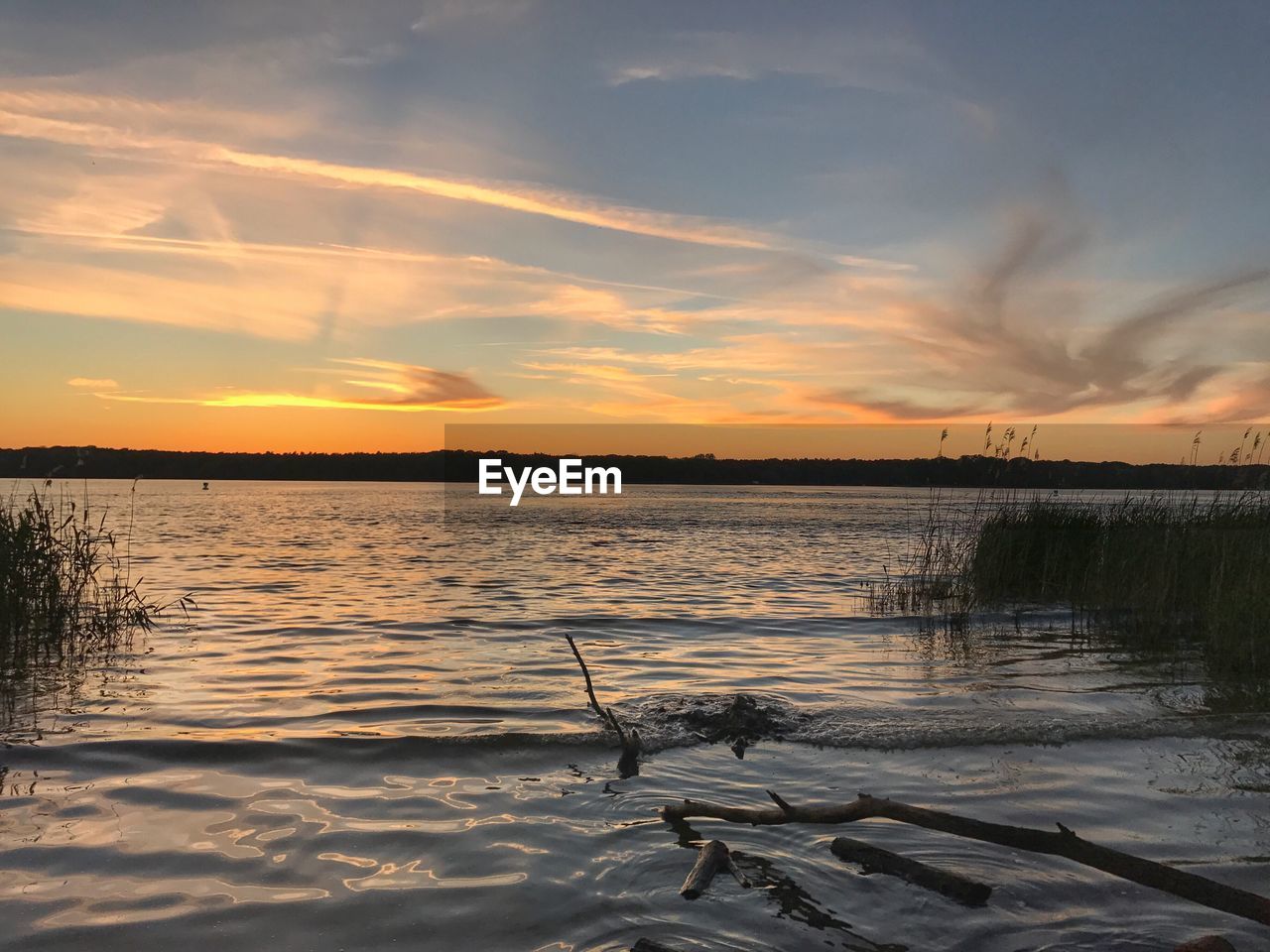SCENIC VIEW OF SUNSET OVER LAKE