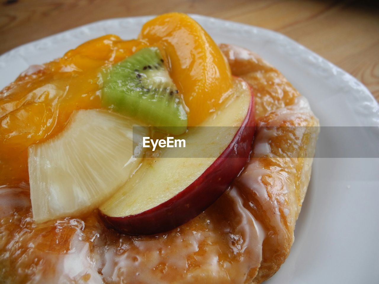 Close-up of serving sweet bun with fruit slices