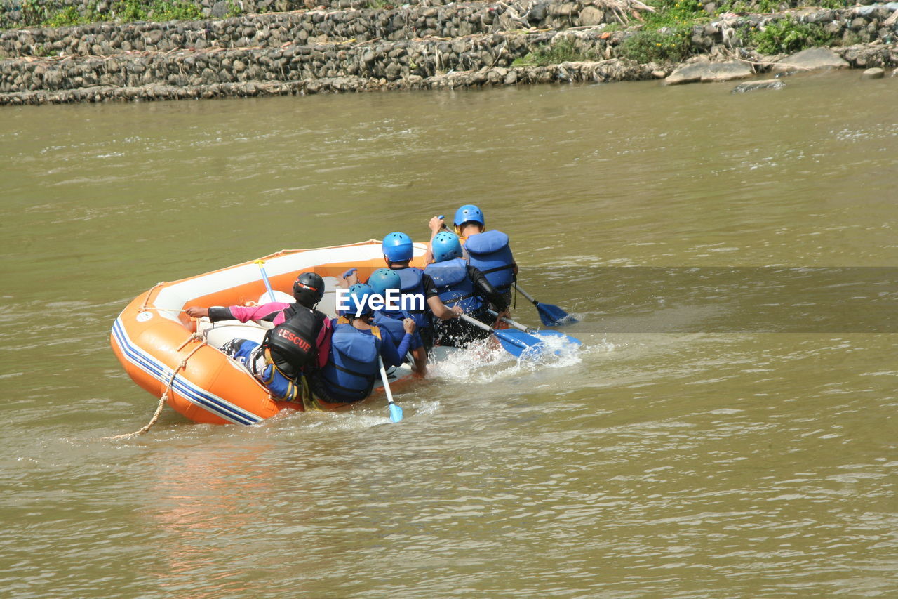 HIGH ANGLE VIEW OF PEOPLE IN BOAT