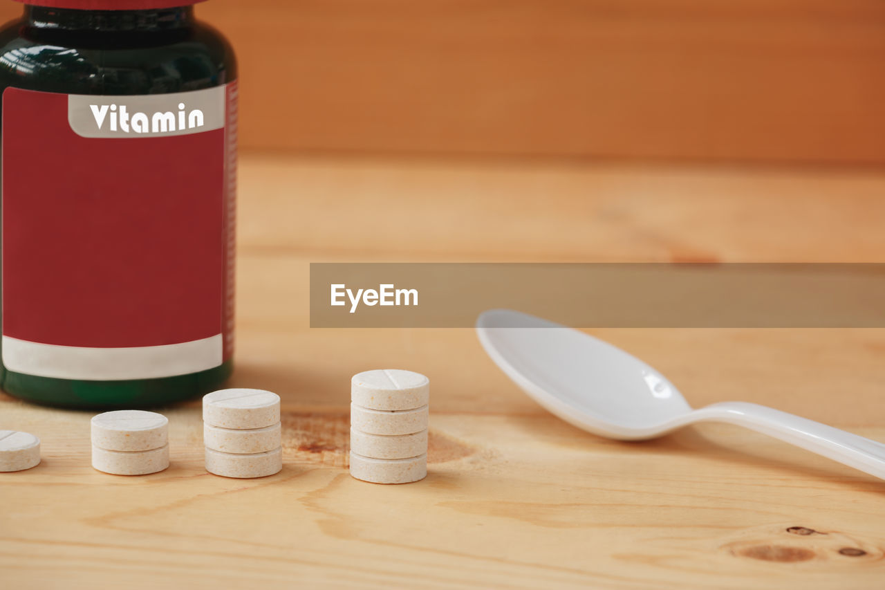 Close-up of medicines on wooden table