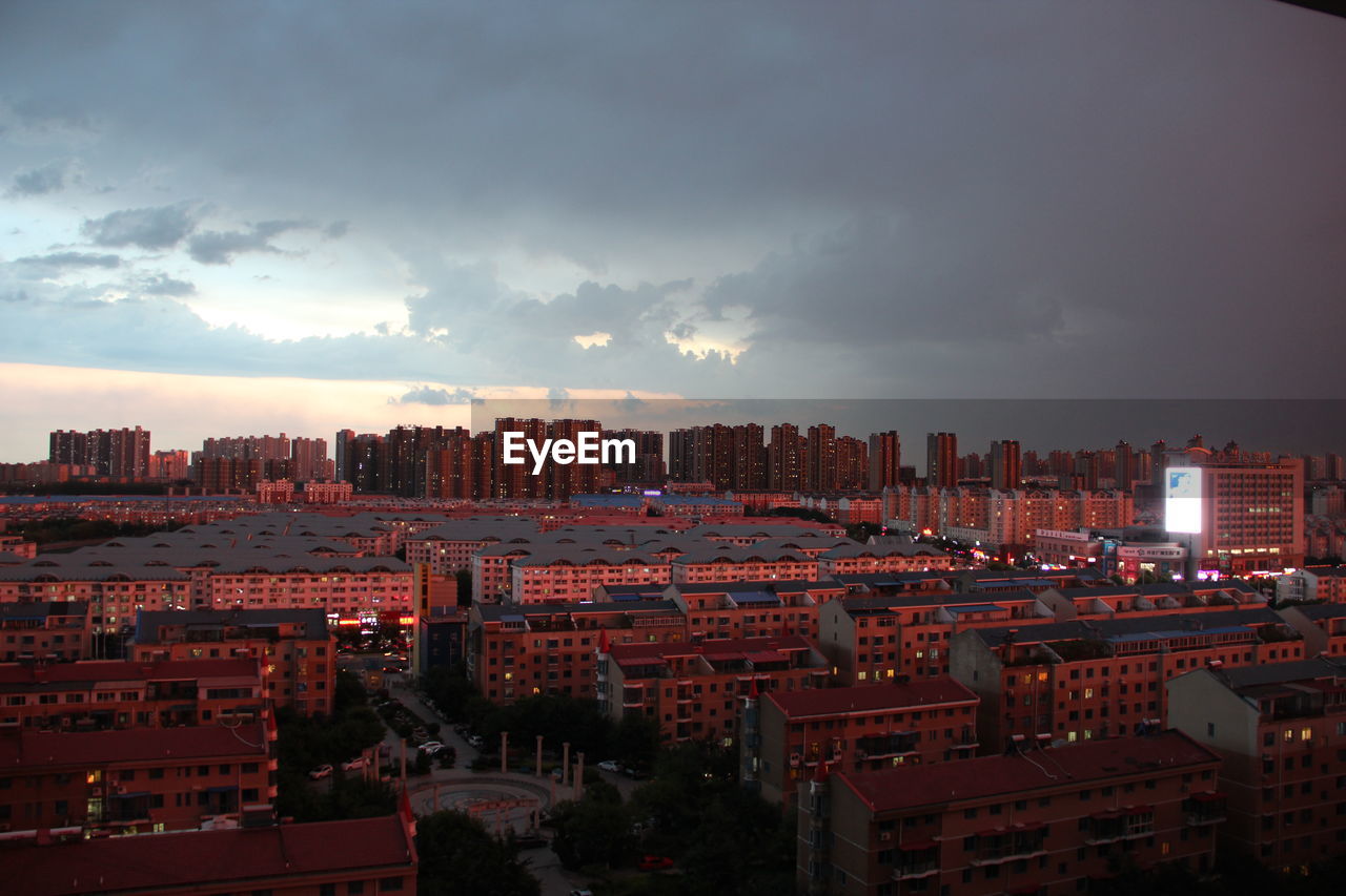 Buildings against cloudy sky