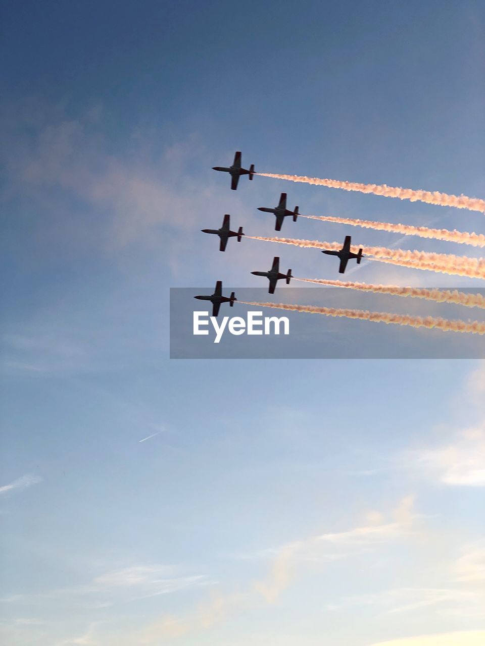 Low angle view of airshow against sky