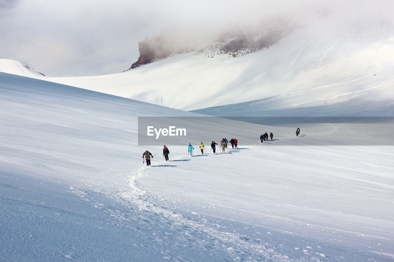 People on snowcapped mountain