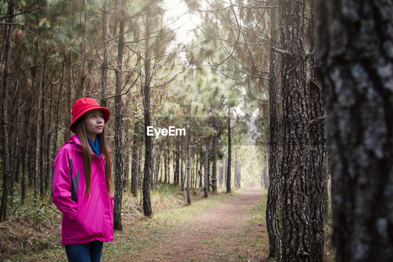 Woman standing amidst trees