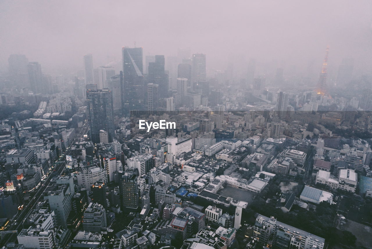 HIGH ANGLE VIEW OF MODERN BUILDINGS AGAINST SKY IN CITY