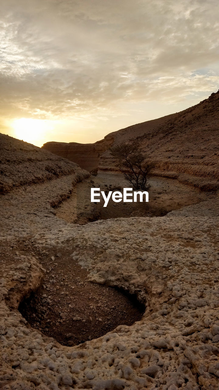 VIEW OF DESERT AGAINST SKY DURING SUNSET