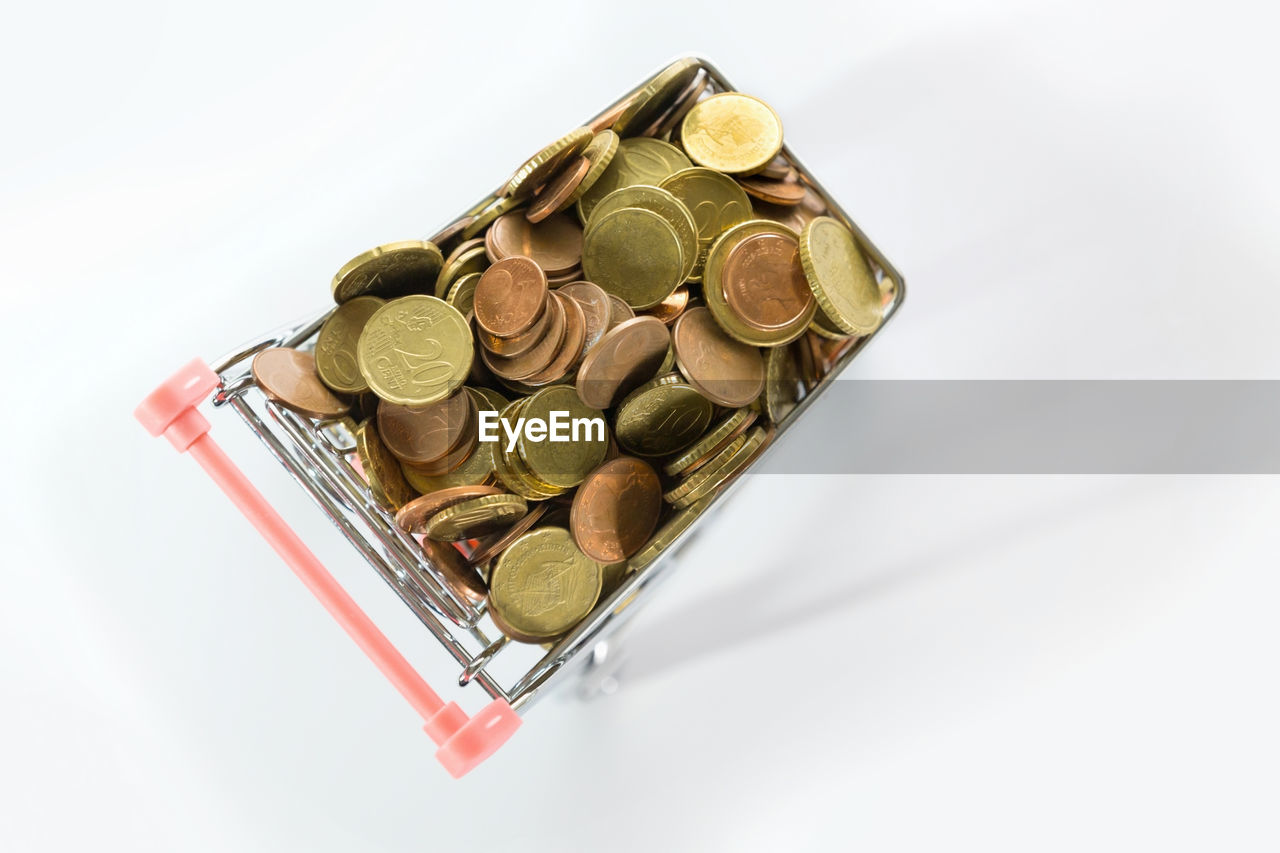 HIGH ANGLE VIEW OF COINS IN CONTAINER