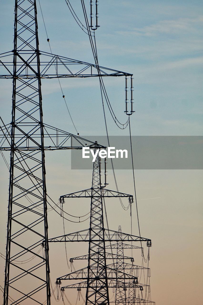 Low angle view of electricity pylon against sky