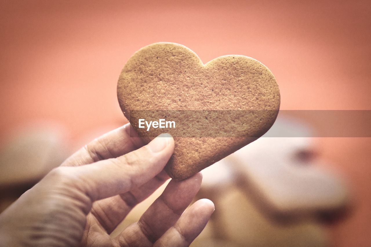 Hand holding a heart cookie